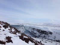 Gullfoss is a massive waterfall on the river Hvita which originates in the glacial lake Langjokull. Gullfoss means 'golden falls' because the glacial sediment in the water turns the falls golden in the sunlight.